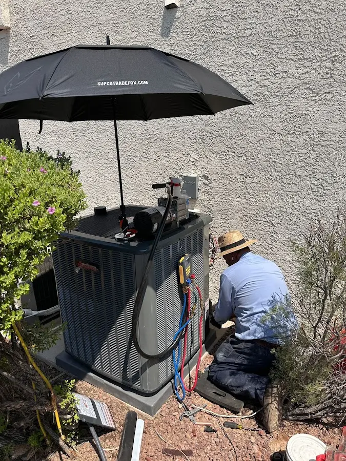 HVAC technician performing outdoor AC maintenance in Bartonville
